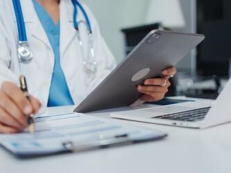 Doctor reviewing notes medical care healthcare apr26_crop